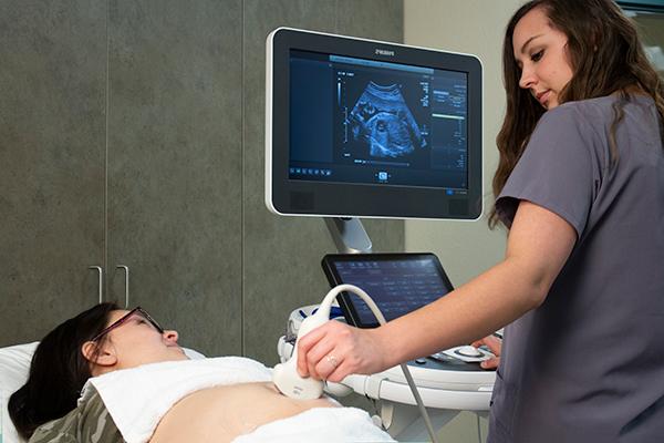 Cardio-Respiratory technician scanning atient.